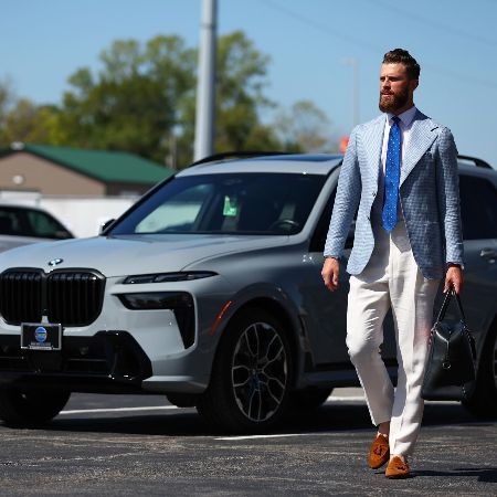Harrison Butker took a picture in a Shepherd outfit in front of a BMW Baron.